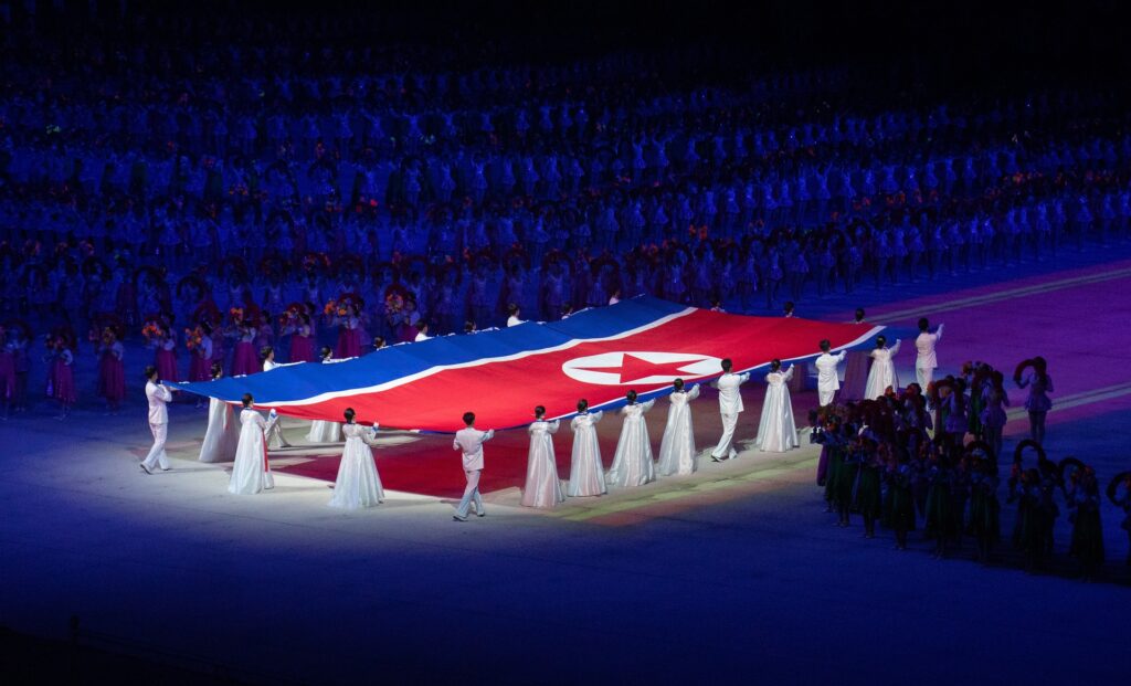 Girls holding the North Korean flag